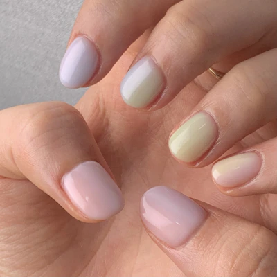 Close-up of elegant nail art featuring soft pink tones, complementing the bag collection.