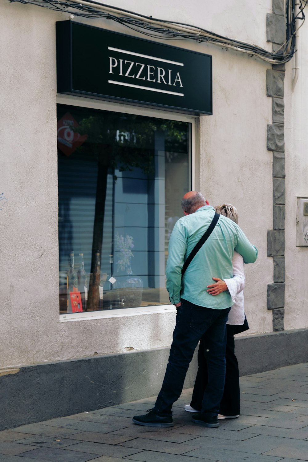 a man and a woman standing in front of a store