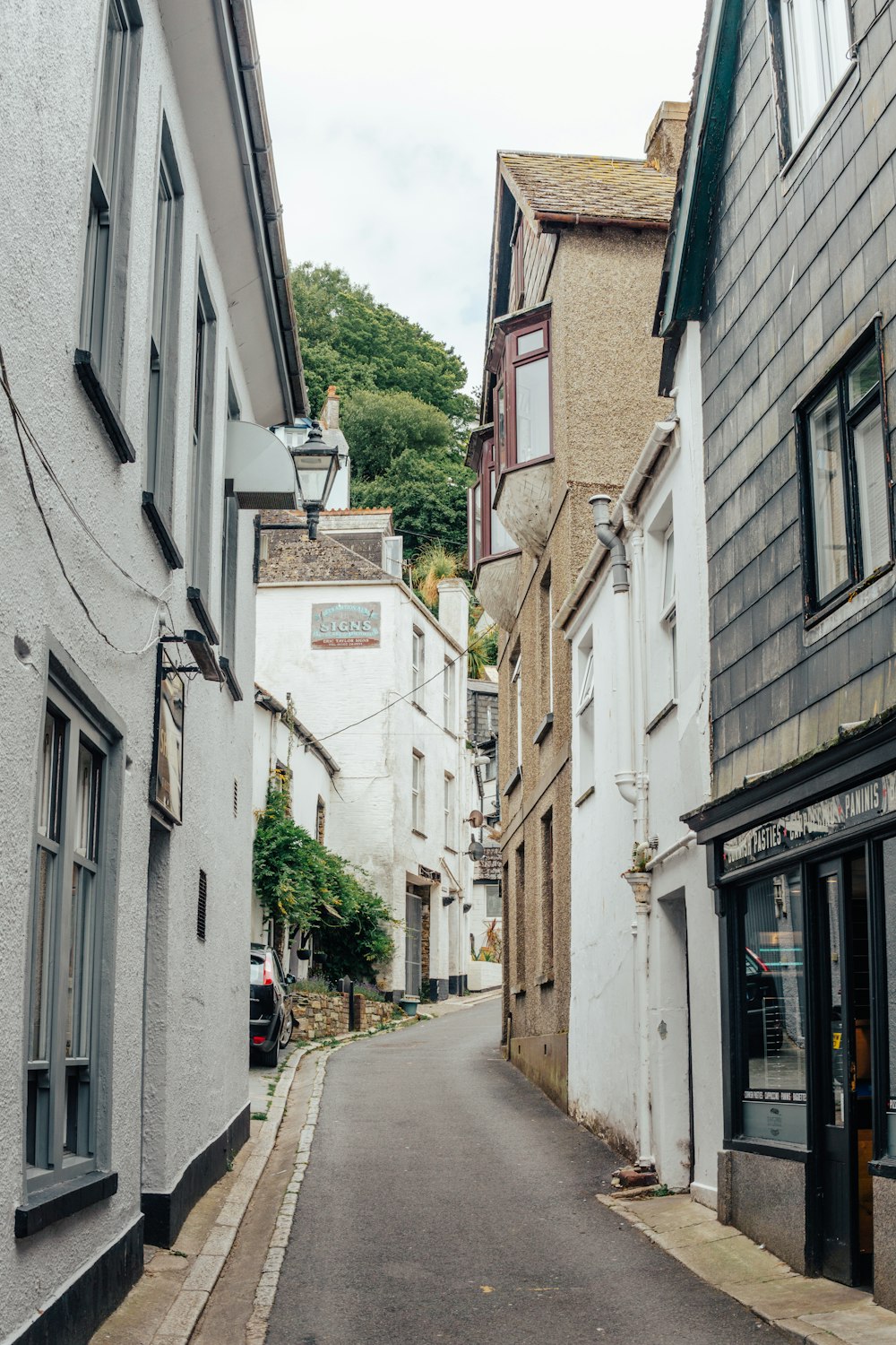 a narrow city street with buildings on both sides