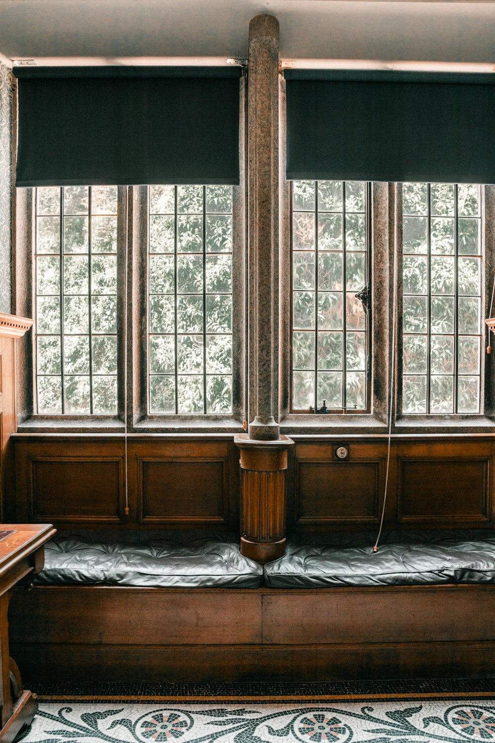 a room with three windows and a bed