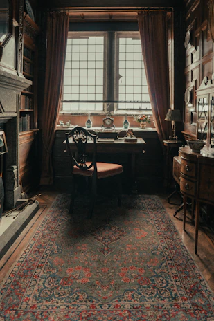 A cozy study corner with plush seating, delicate floral accents, and warm lighting.