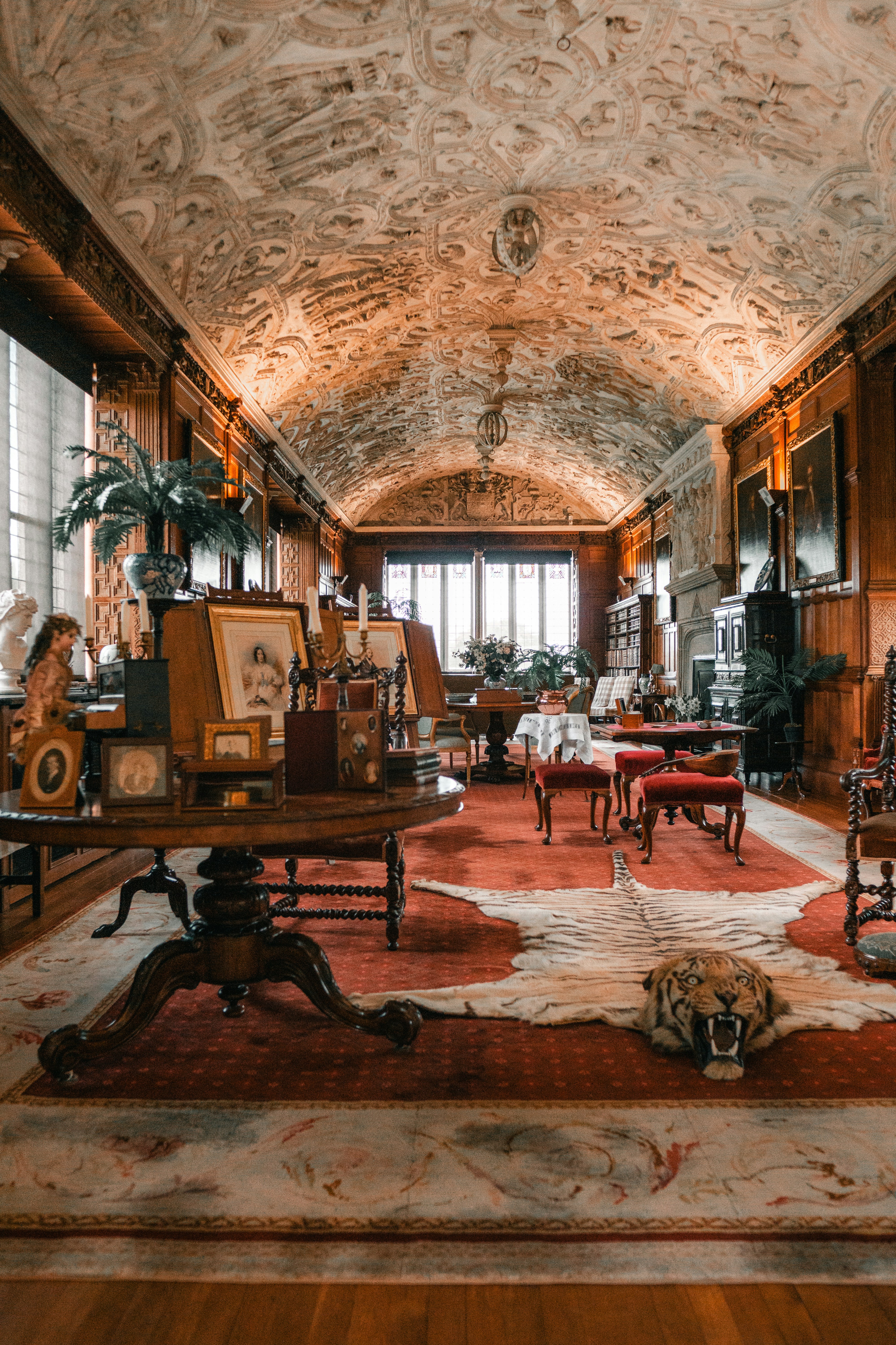 a living room with a rug, chairs and a table