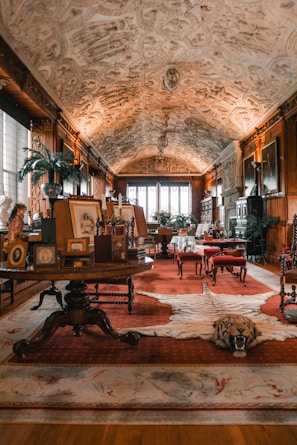a living room with a rug, chairs and a table