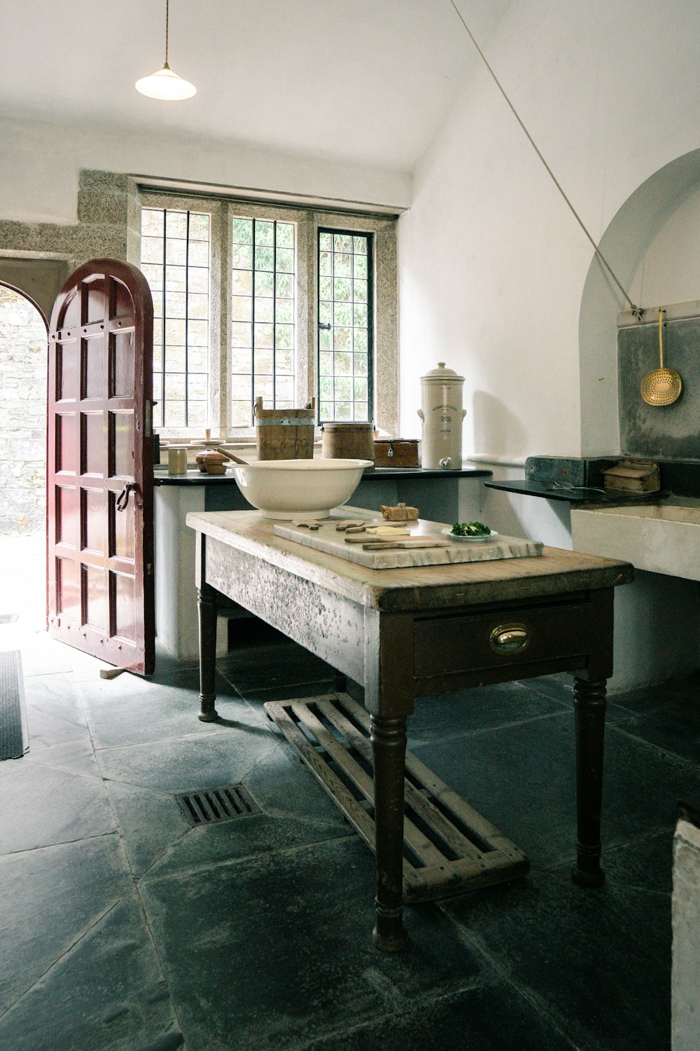 a kitchen with a table and a sink in it