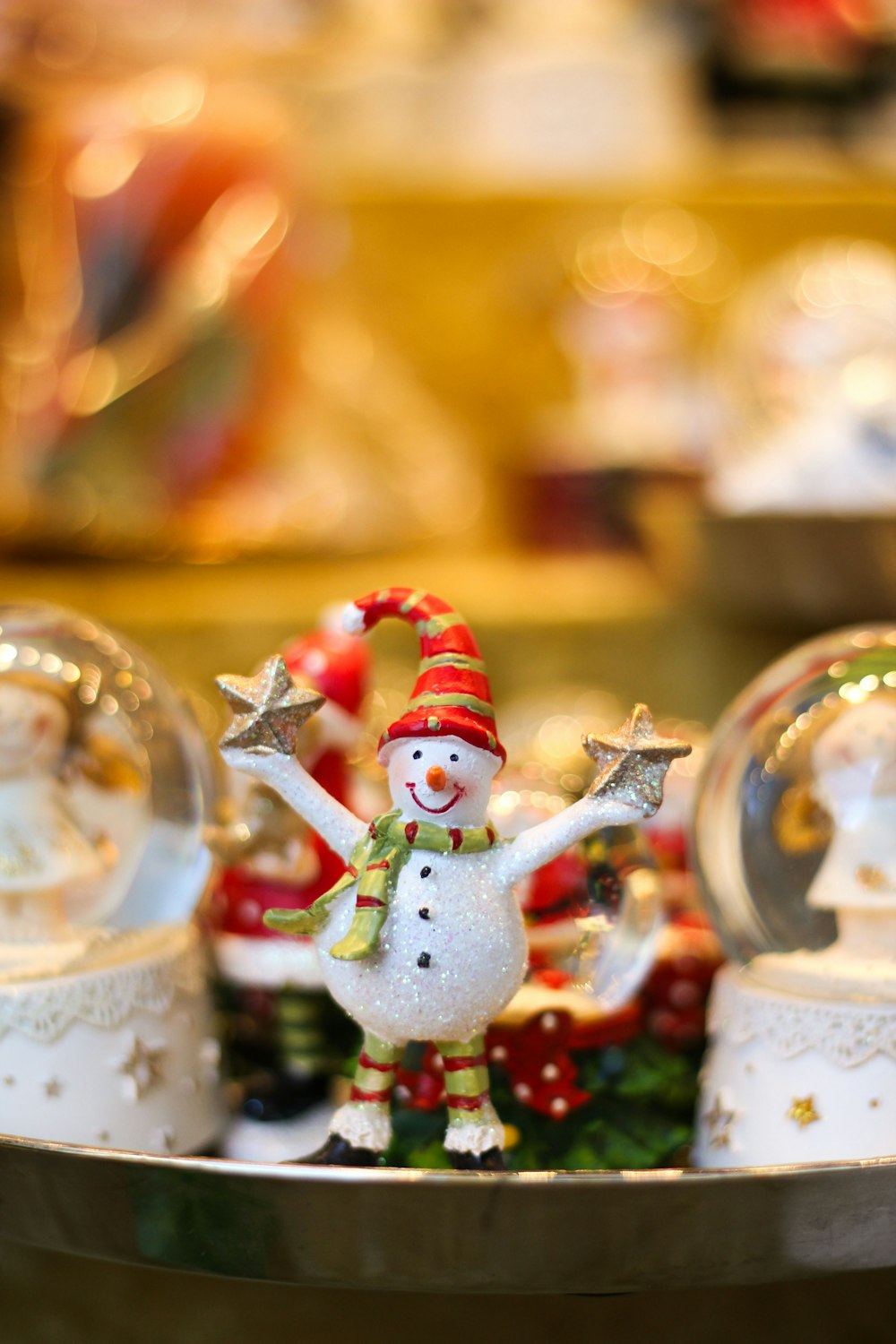 a snowman figurine in a silver tray