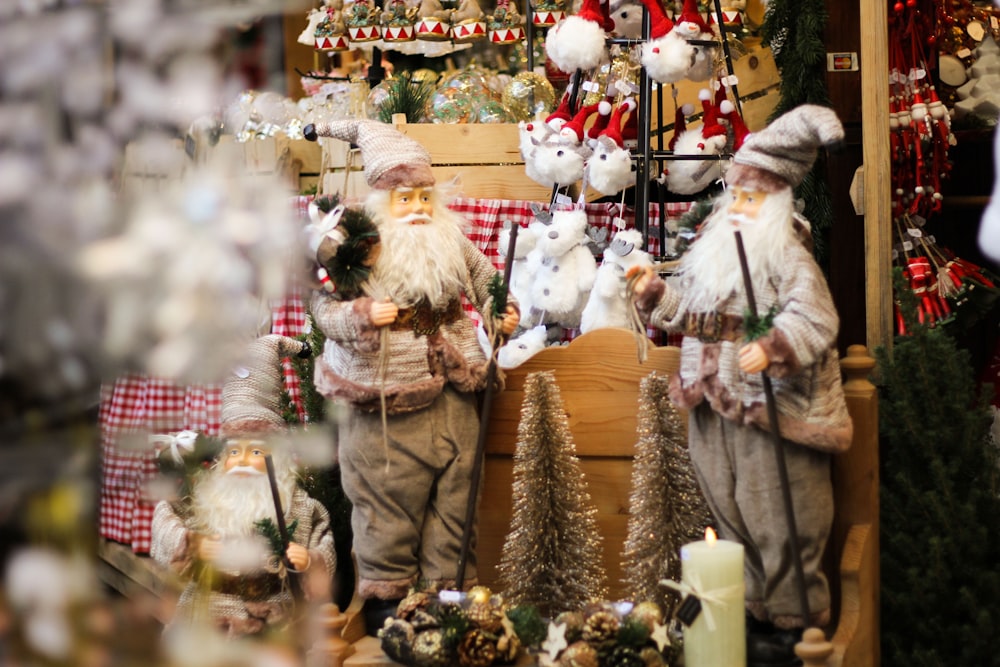 a couple of statues of santa claus in a store