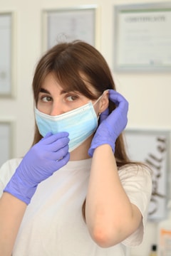 a woman wearing a face mask and gloves