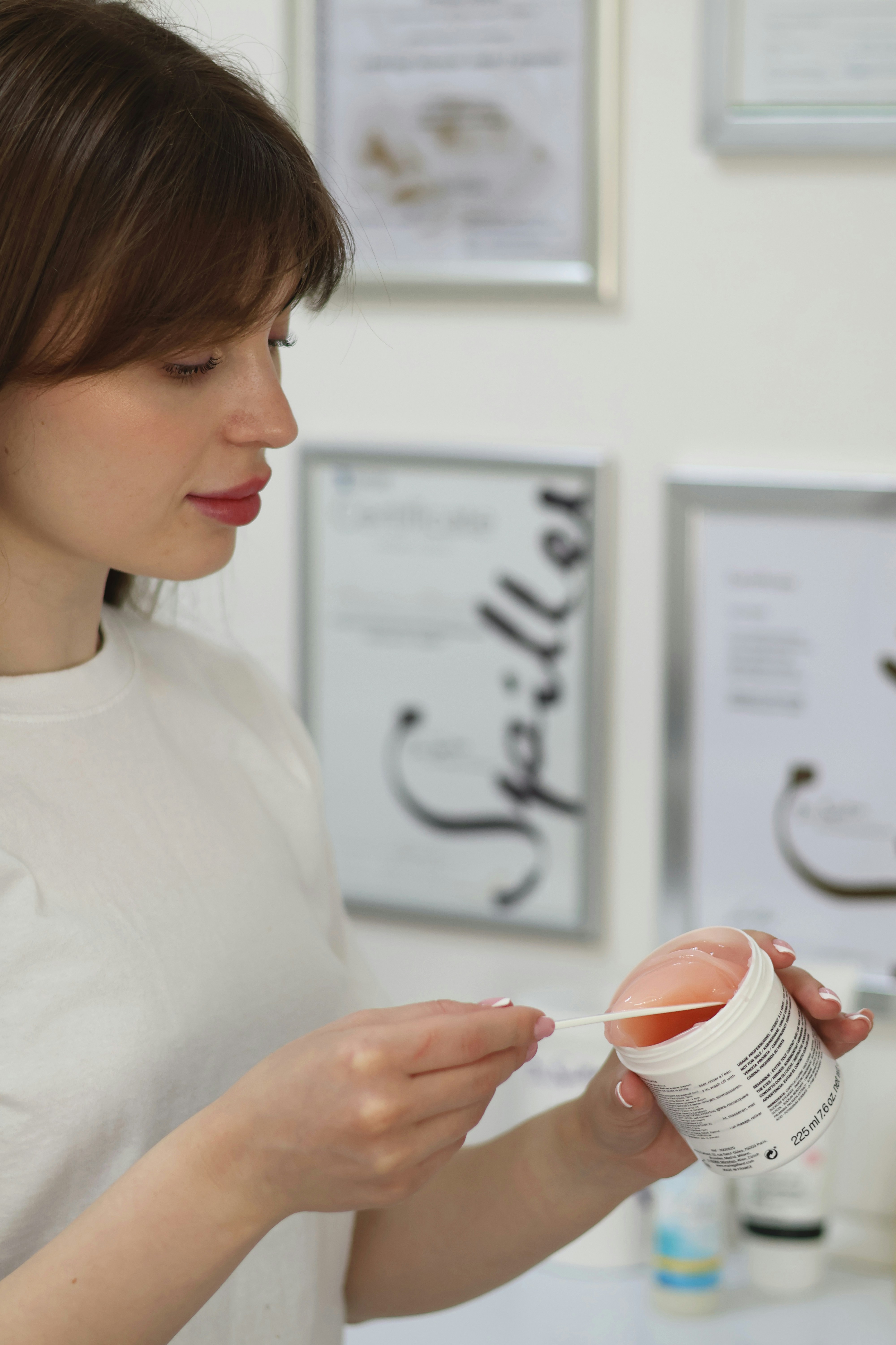 a woman in a white shirt is holding a container of food