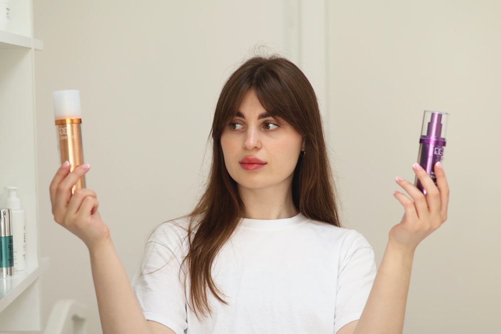 a woman holding two different types of skin care products