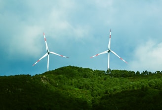 a couple of windmills that are on a hill