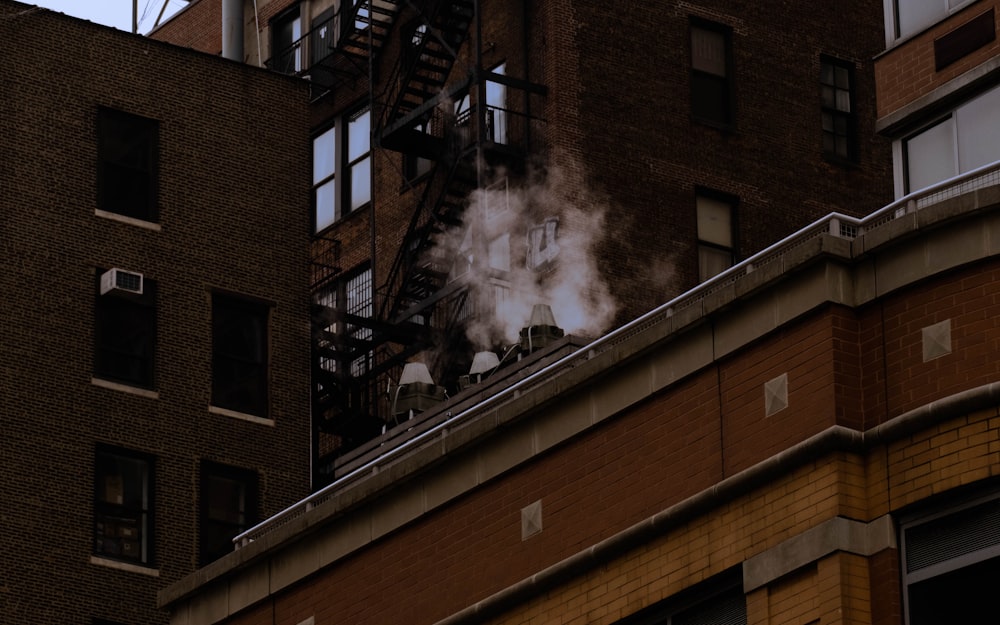 smoke billows from the roof of a building