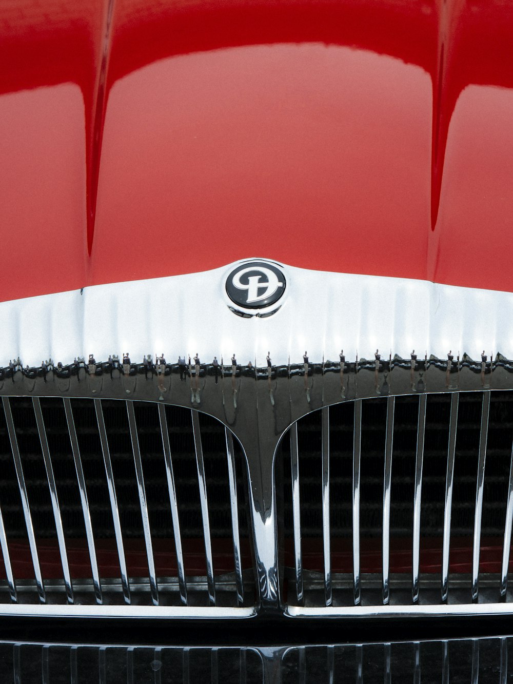 a close up of the front grill of a red car