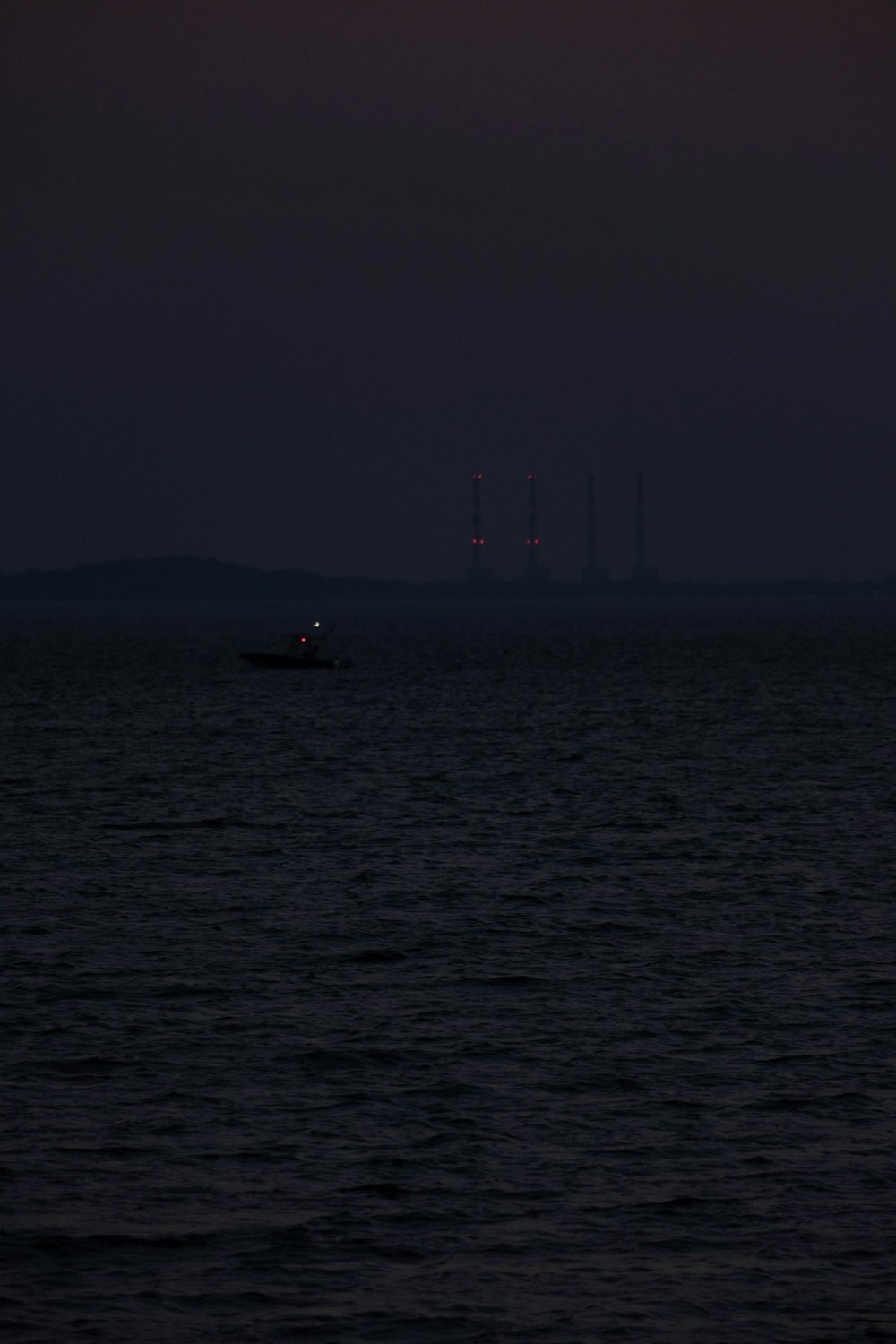 um barco está no oceano à noite