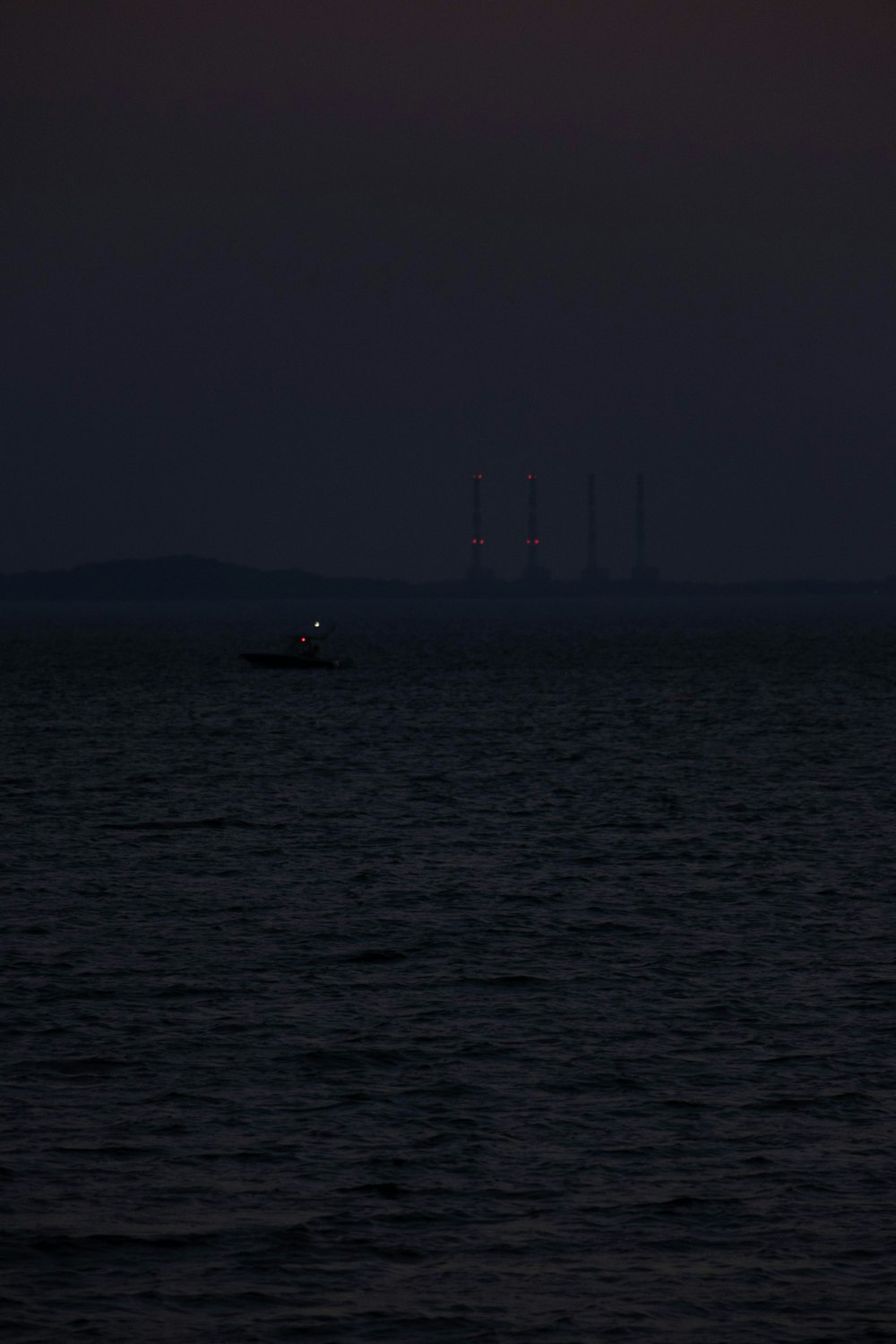 a boat is out in the ocean at night