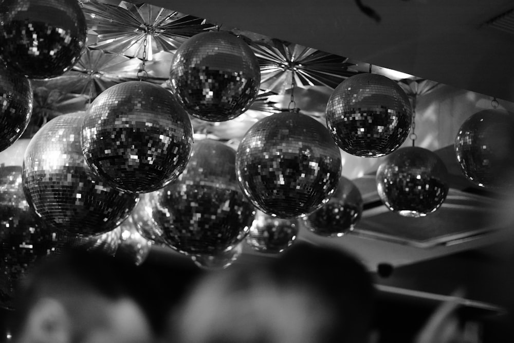 a bunch of shiny disco balls hanging from a ceiling