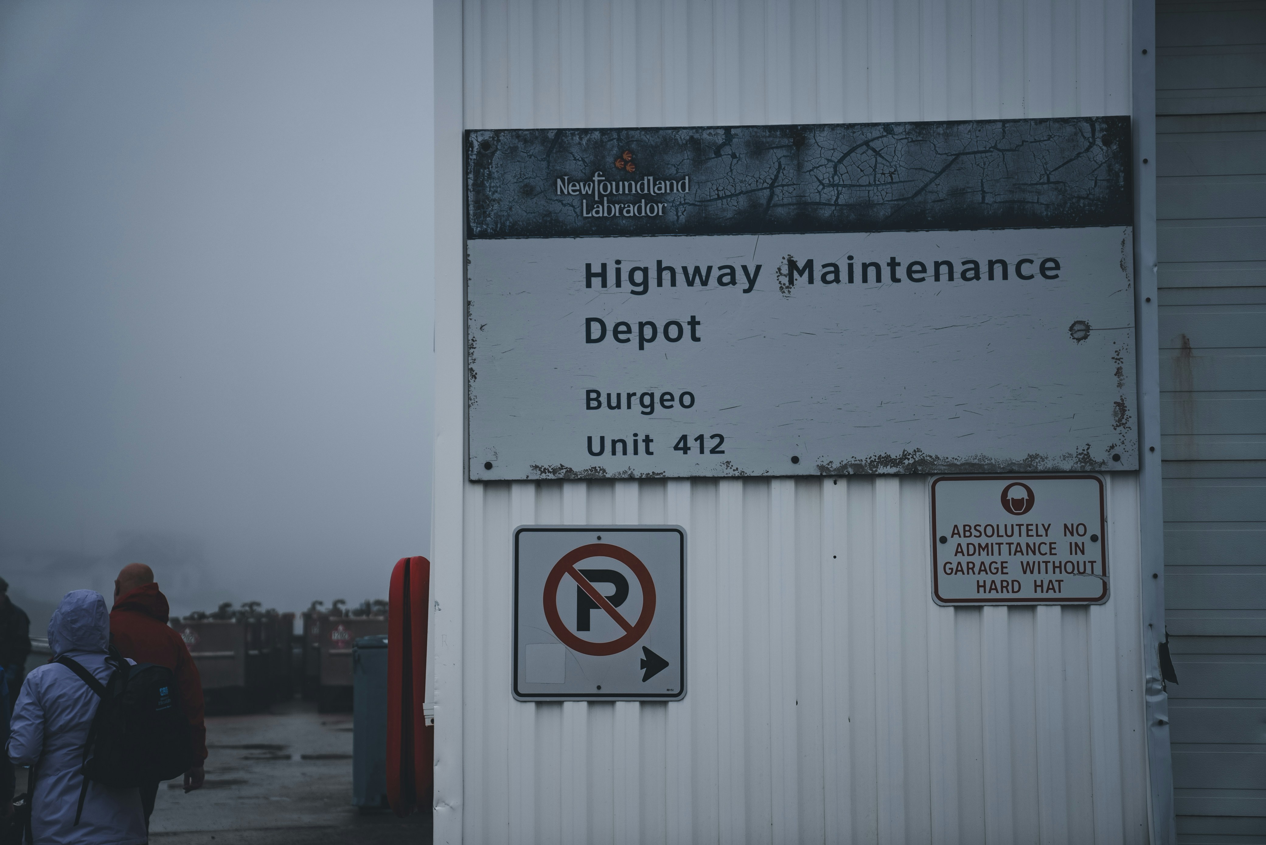 a sign on the side of a building that says highway maintenance depot buggo unit