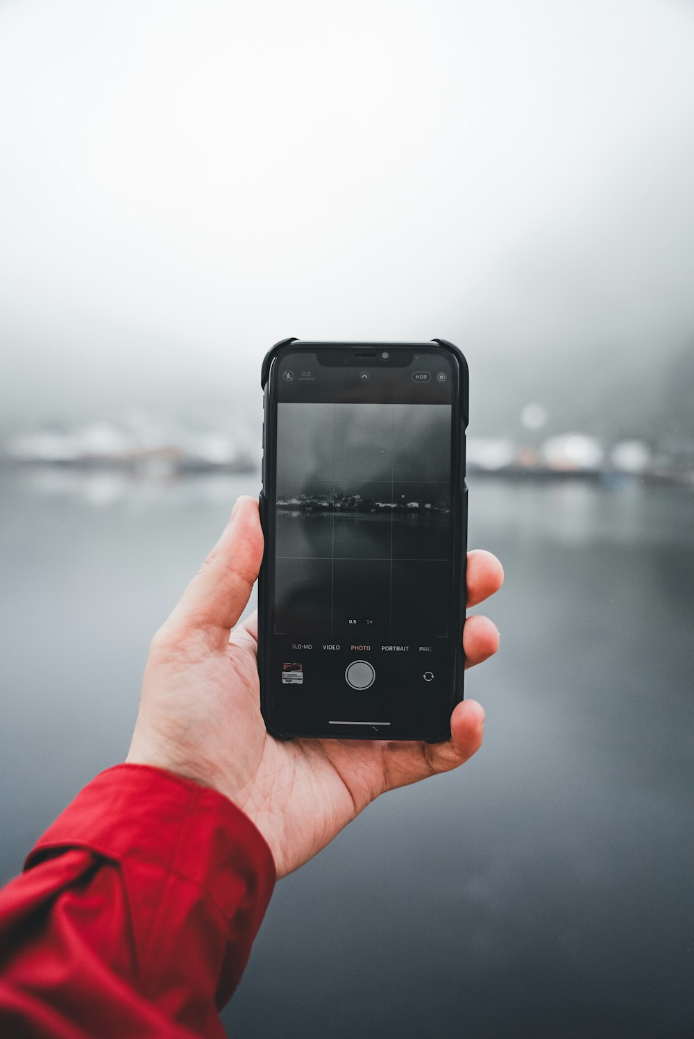 a person holding a cell phone in their hand