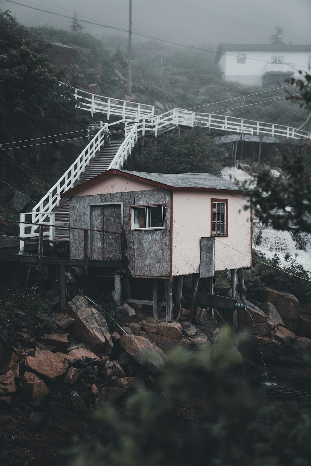 a small house sitting on top of a pile of rocks