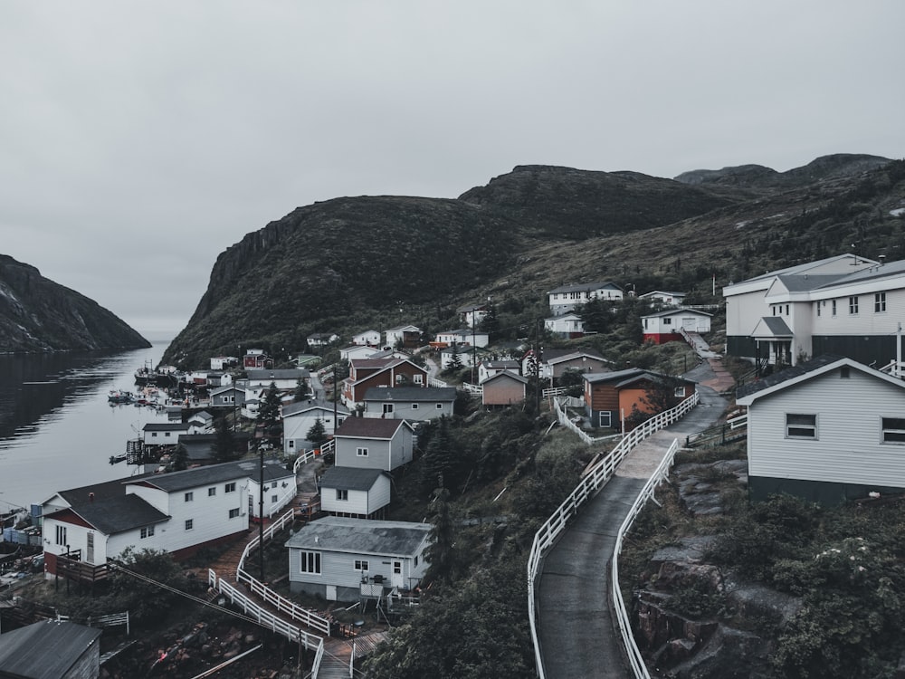 a small town on a hill next to a body of water