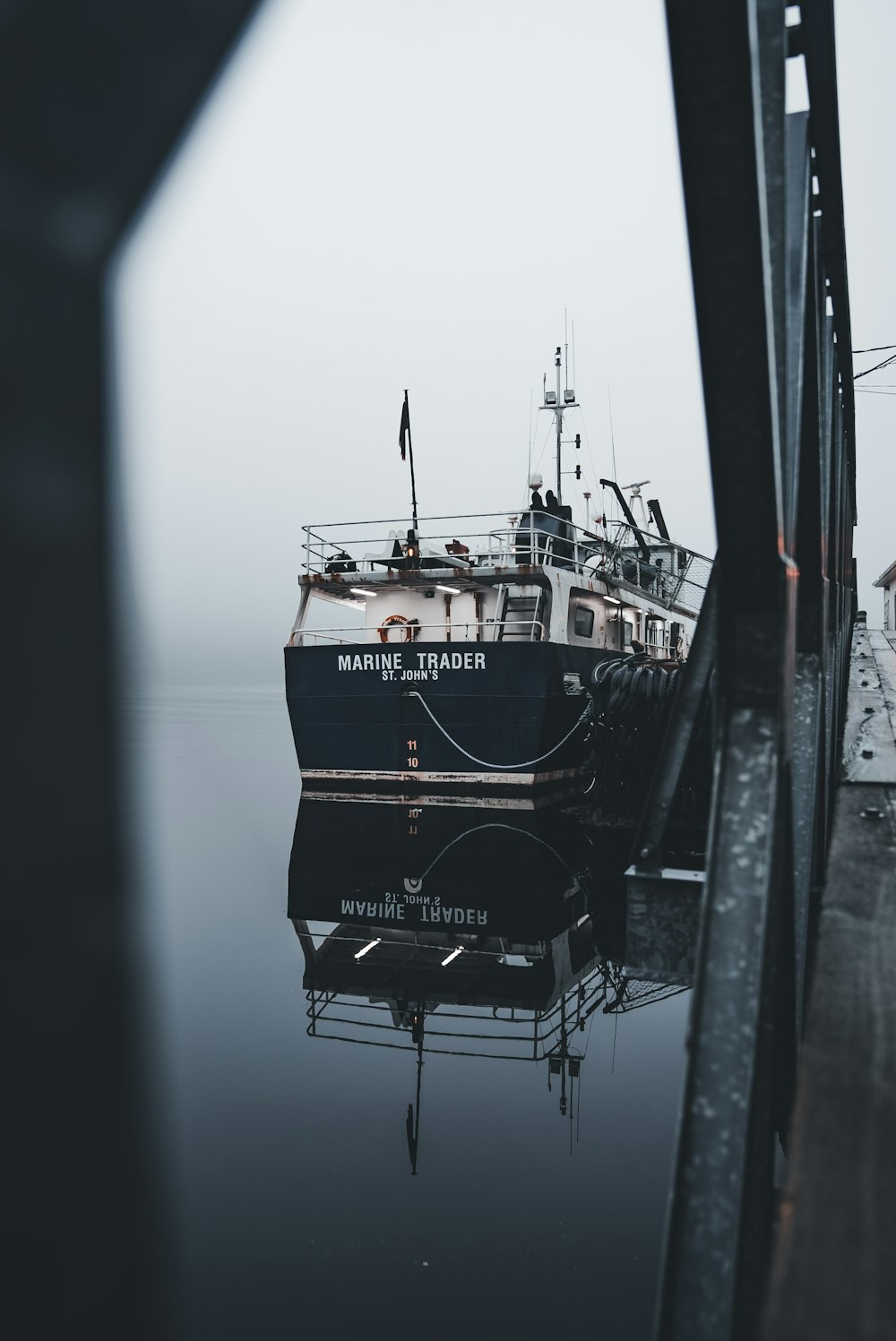 a boat is docked at a dock on a foggy day