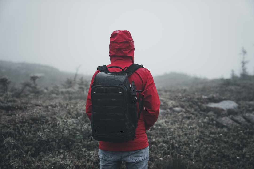 a person in a red jacket with a backpack,
