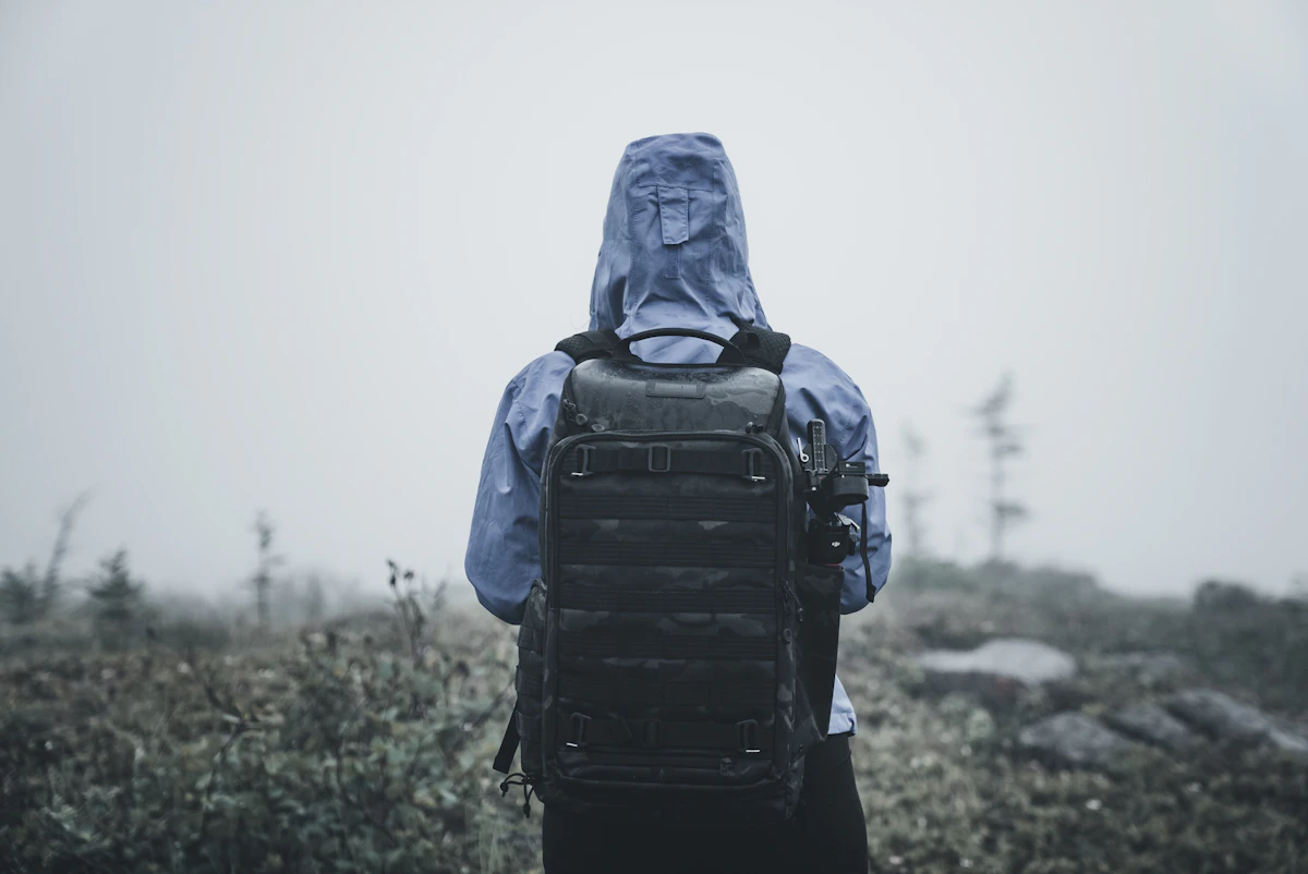 a person in a hooded jacket with a backpack