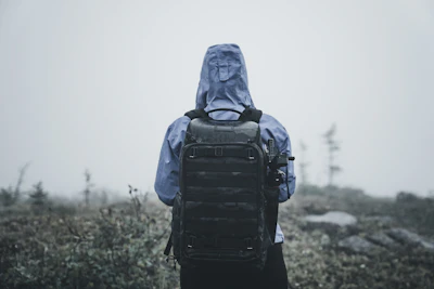 a person in a hooded jacket with a backpack