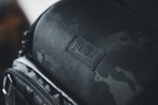 a close up of a black backpack with a tag on it