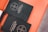 Two black books titled 'The Book of Alternative Services of The Anglican Church of Canada' are placed on an orange surface. The cover features a simple cross emblem.