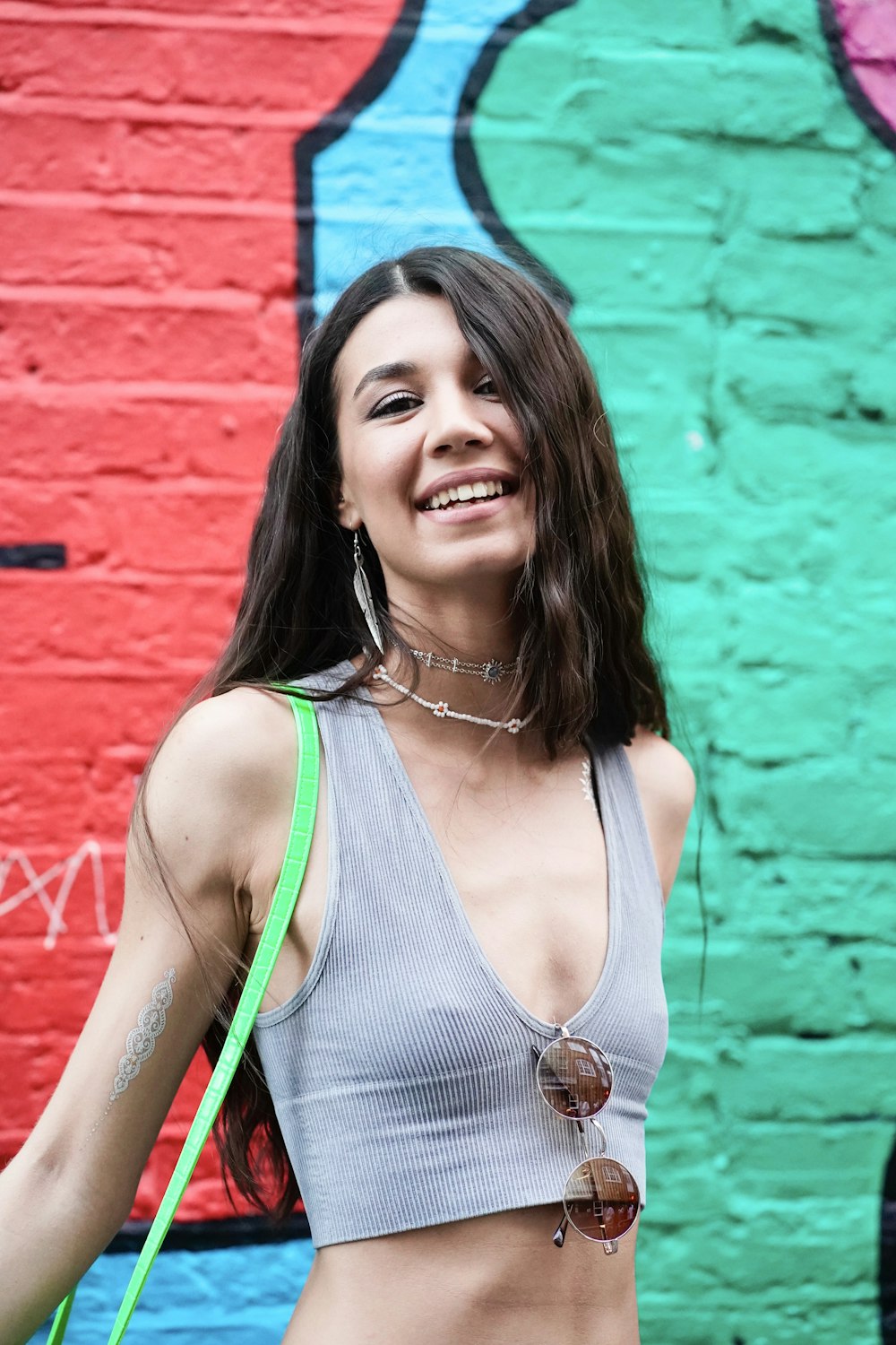 a woman standing in front of a colorful wall