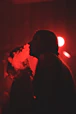 woman smoking weed in warehouse party