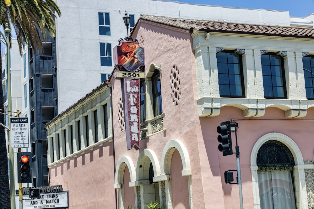 a pink building with a neon sign on the front of it