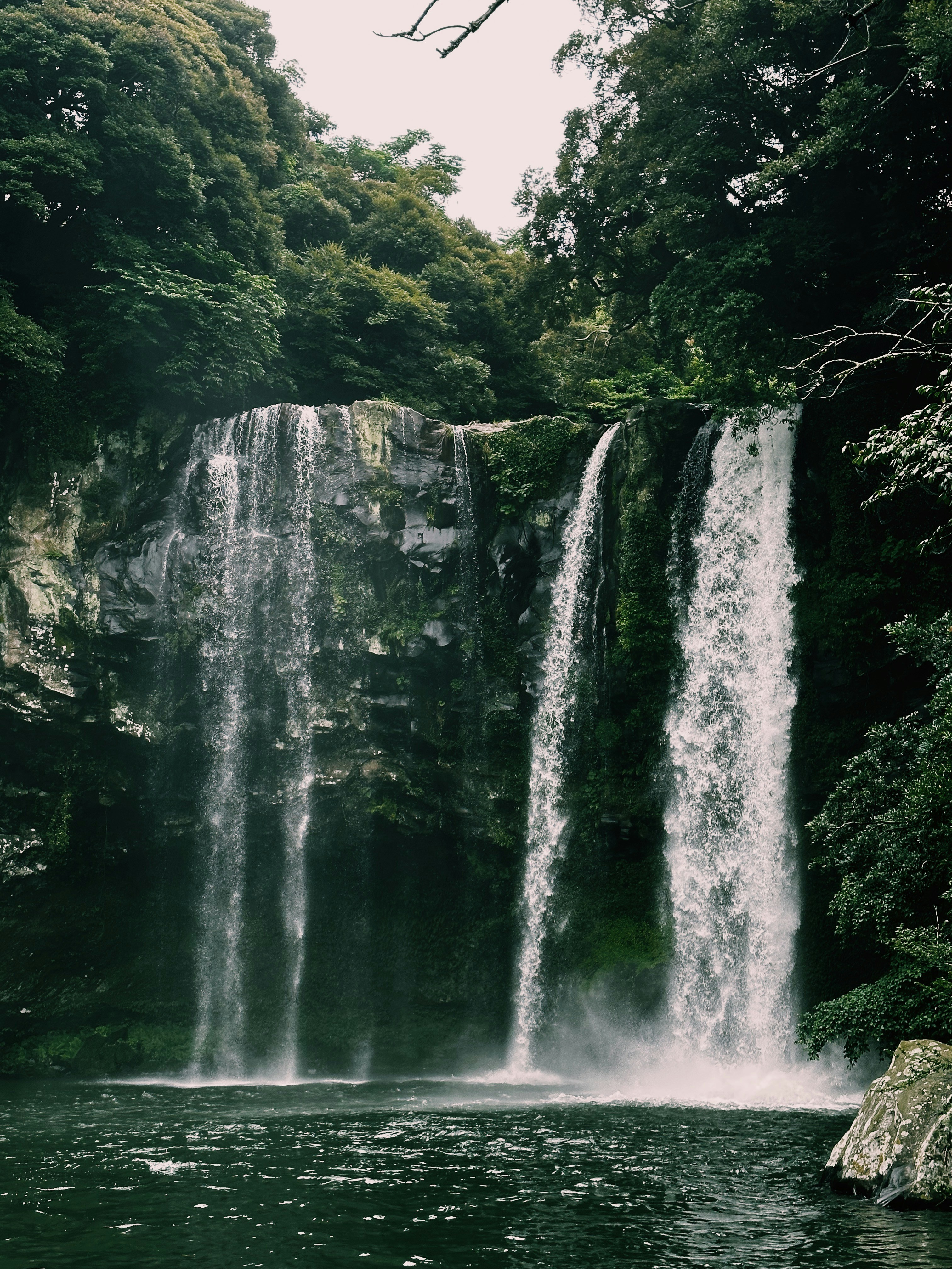 a large waterfall is in the middle of a body of water