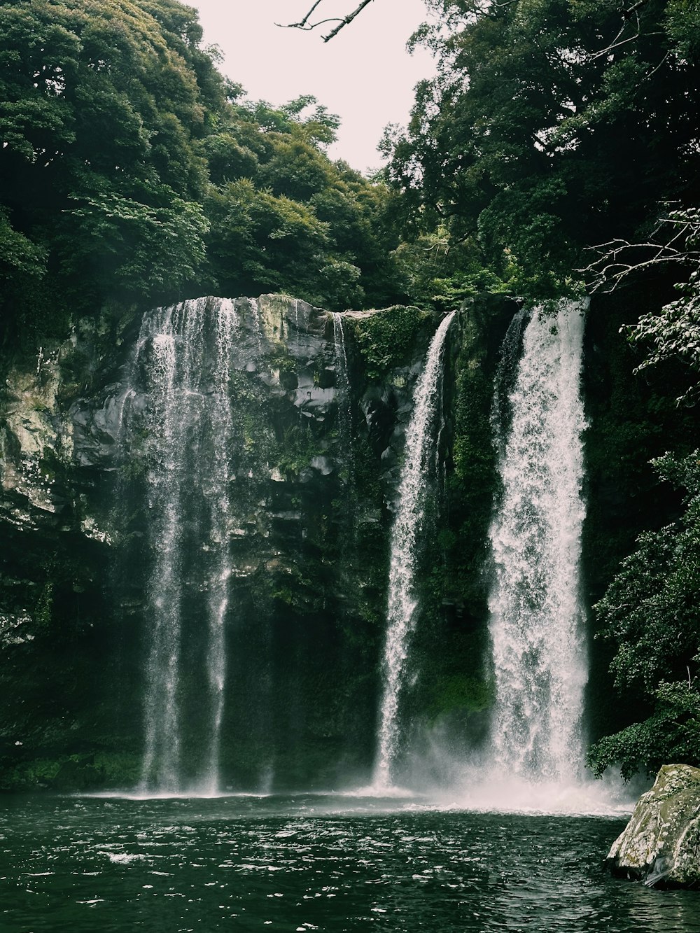 a large waterfall is in the middle of a body of water