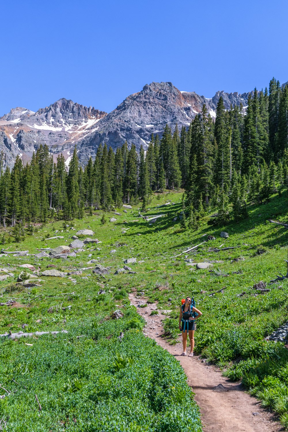 a couple of people that are walking on a trail