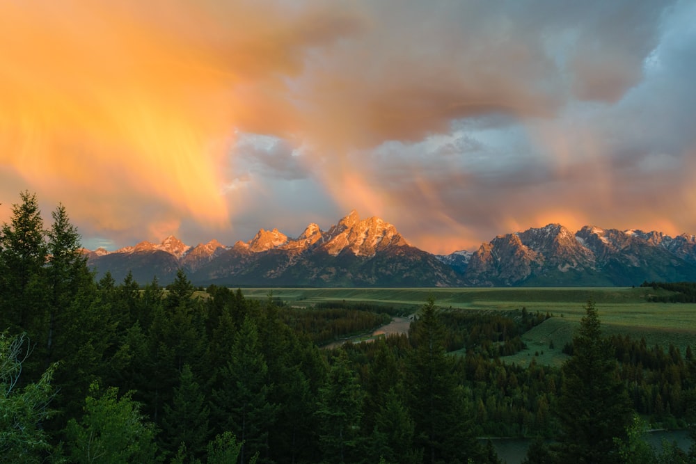 a sunset view of the grand tetons and the snake river