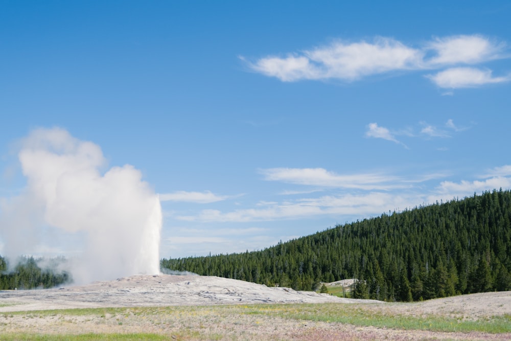 a large geyser spewing out water into the sky