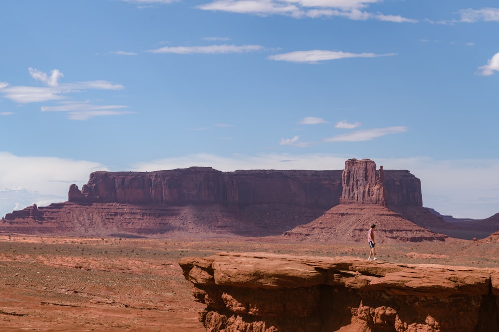 a person standing on top of a rock formation