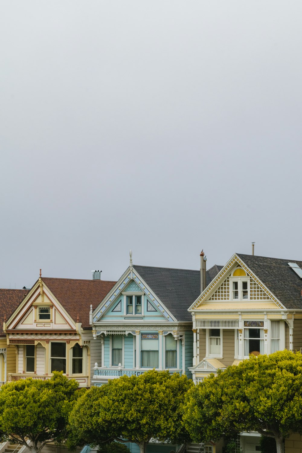 a row of houses with a clock tower in the background