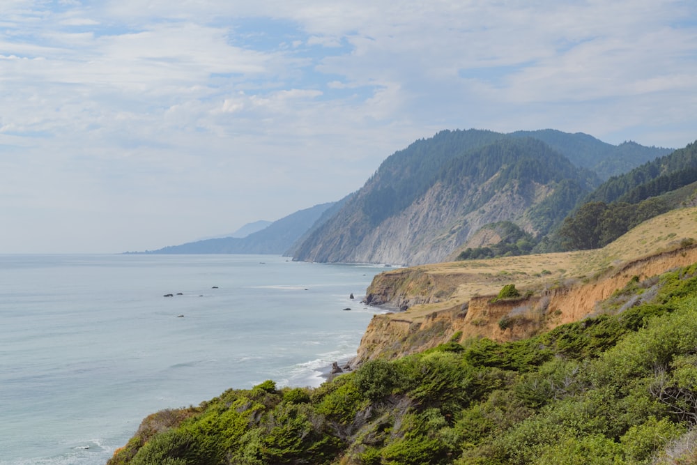 a scenic view of the ocean and mountains