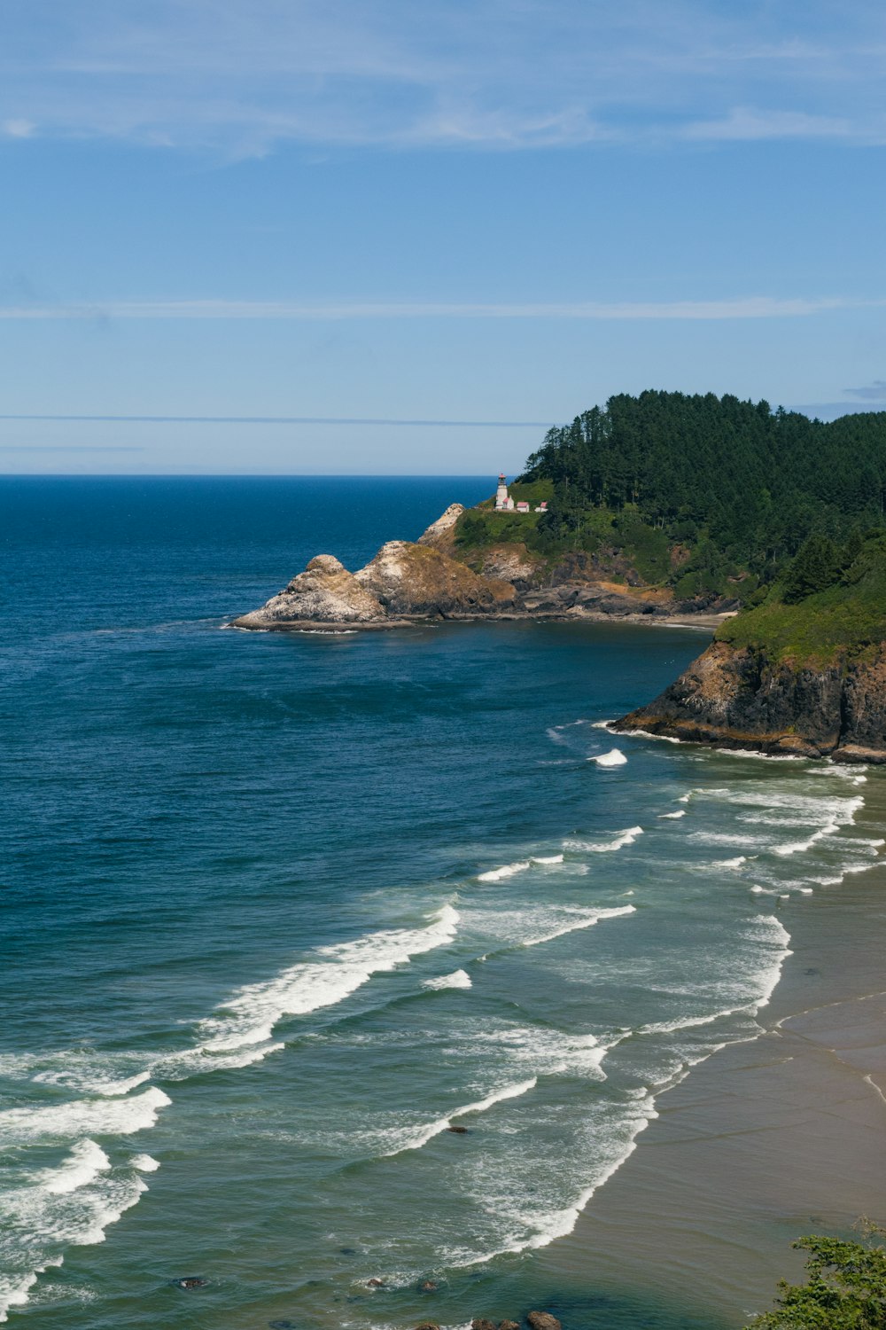 a view of a beach with a cliff in the background