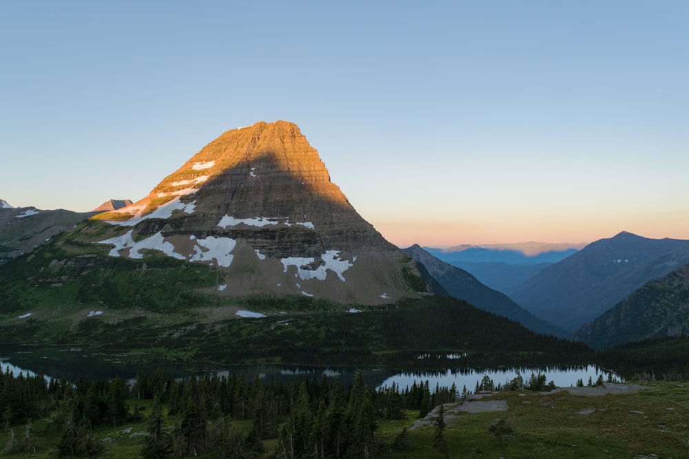 a view of a mountain with a lake in the foreground