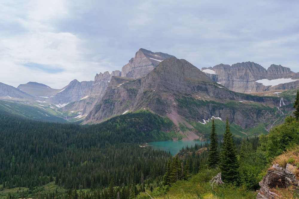 a view of a mountain range with a lake in the foreground