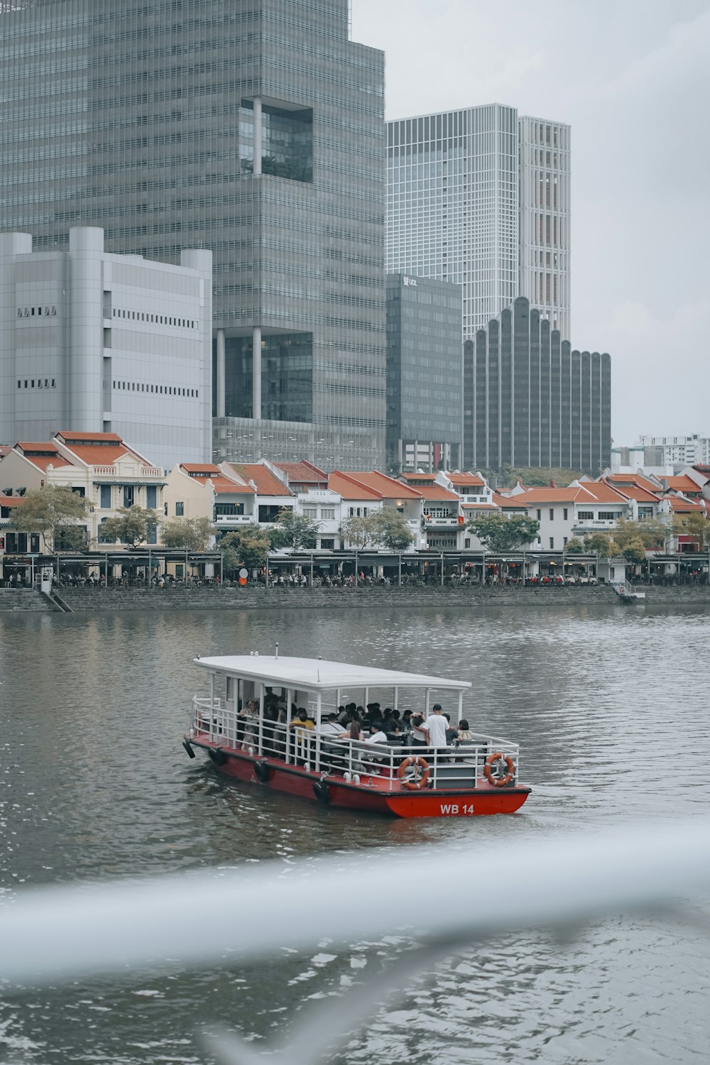 a red and white boat in a body of water