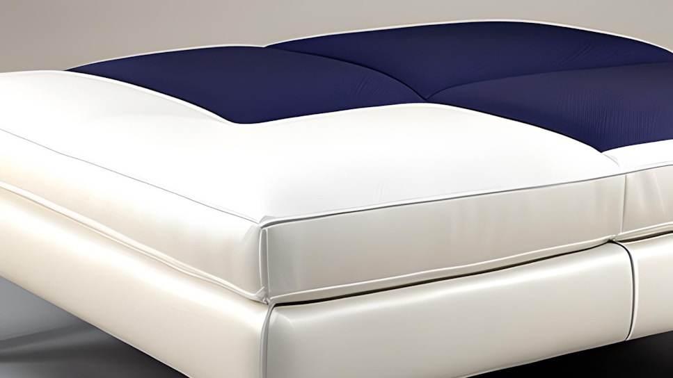 A modern bed with a sleek, minimalist design featuring a padded blue and white mattress. The textures appear soft and comfortable, suggesting luxury and relaxation.