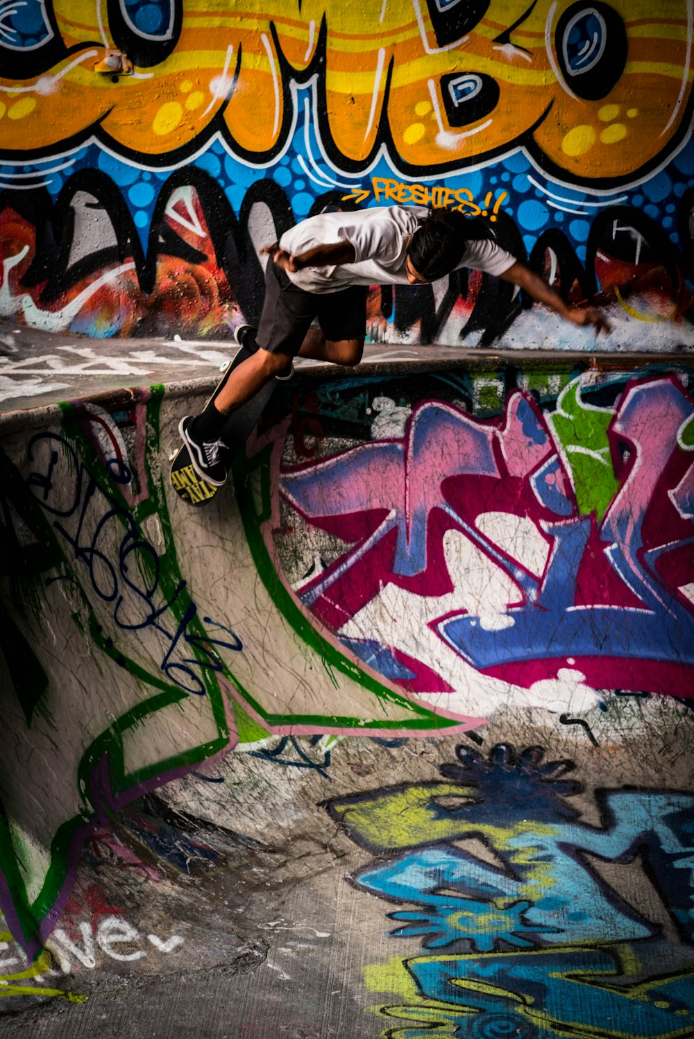 a man riding a skateboard up the side of a ramp