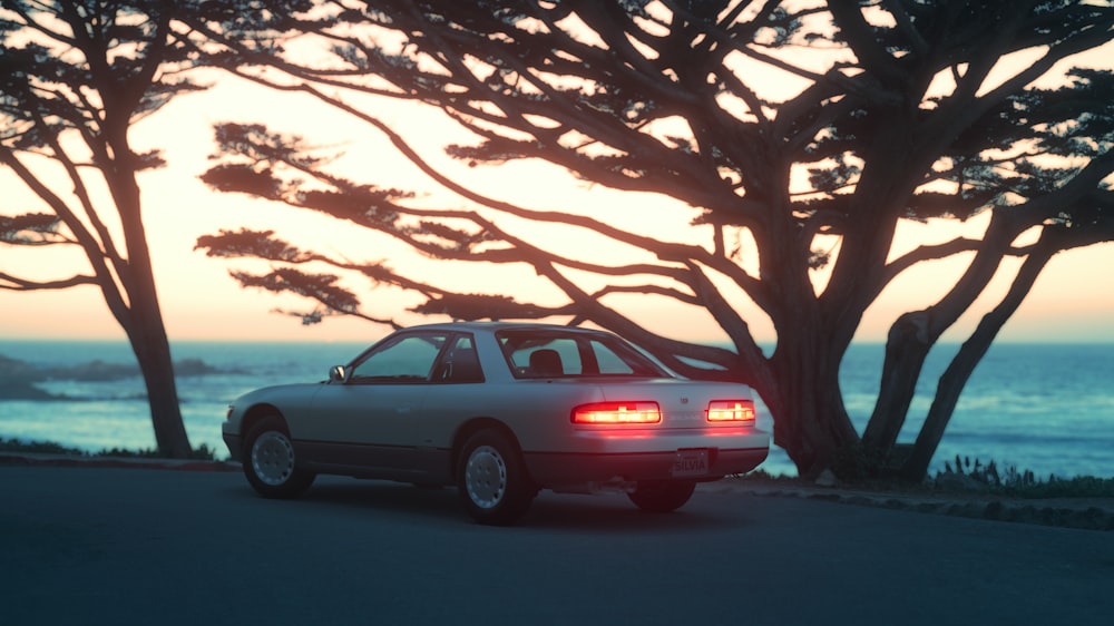 a car parked on the side of a road near trees