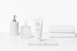 Elegant spa essentials arranged neatly on a sleek white surface, evoking luxury and calm.
