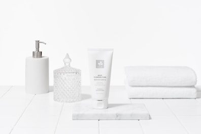 Elegant packaging of reparatúr's gentle cleansers placed on a marble countertop.