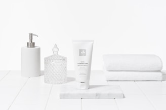 Elegant packaging of reparatúr's gentle cleansers placed on a marble countertop.